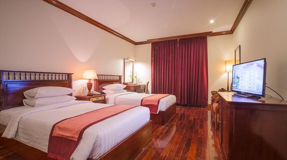 French colonial hotel with warmly decorated rooms