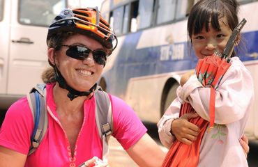 Cyclist posing with little Vietnamese girl