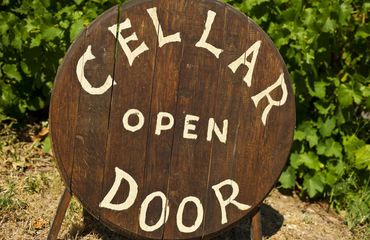 Wine barrel sign for 'cellar door open'