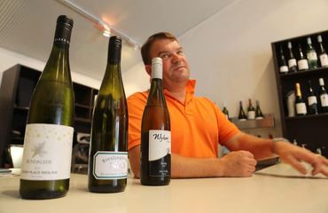 Man with bottles of wine ready for tasting