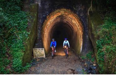 Cyclists coming out of a rail tunnel