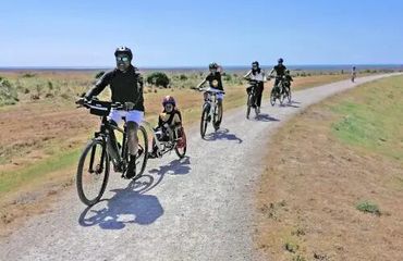 Family cycling on trail