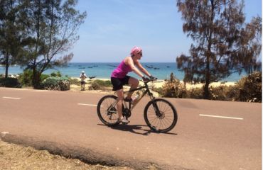Cyclist with beach in background