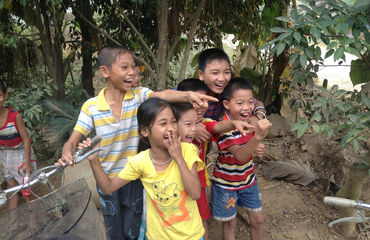 Local children laughing and pointing