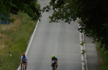 Two cyclists on a quiet stretch of road