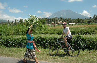 Cyclist and Balinese woman