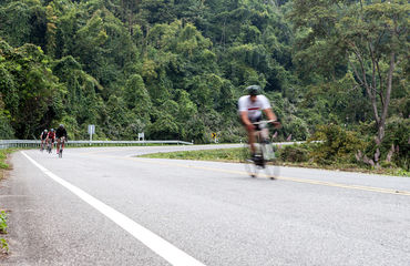 Cyclist sprinting away from the group