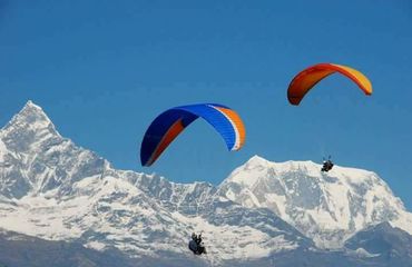 Paragliding with mountains behind