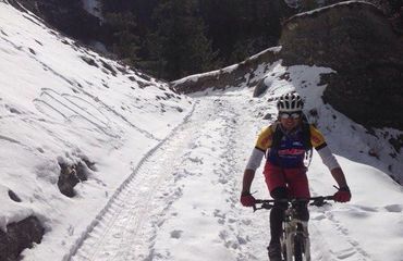 Cyclist riding through the snow