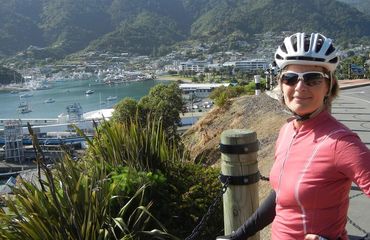 Cyclist posing with Picton behind