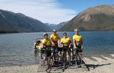 Group of cyclists posing at lake