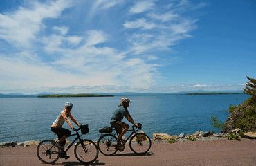 Cyclists riding next to water