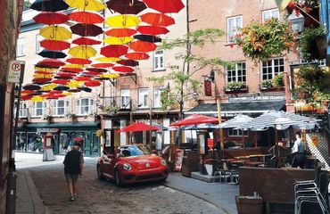 Colorful street with hanging umbrellas