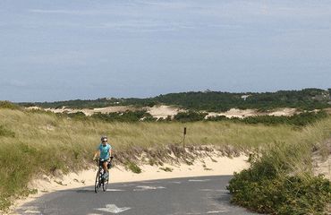 Cyclist riding the sand dune roads