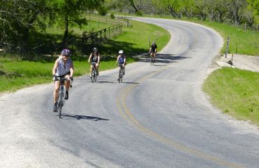 Cyclists riding on bendy road