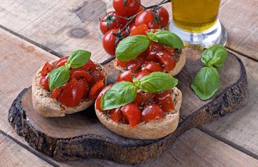 Tomato and basil bread on wooden slab