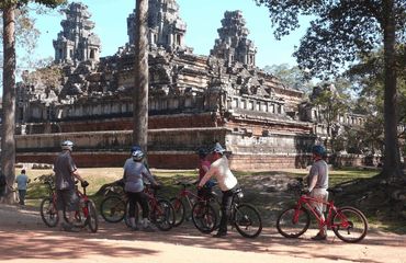 Cyclists stopped outside of temple