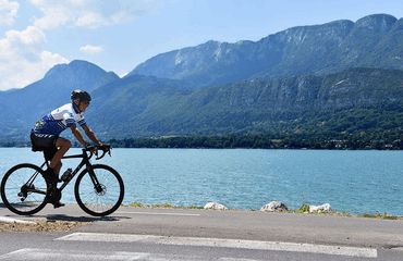 Biking past lake and mountains