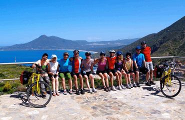 Cycling group posing at viewpoint