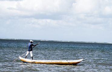 Fisherman rowing on ocean