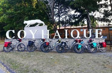 Sign for Coyhaique with bikes resting