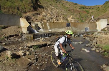 Cycling across a stream and a dam wall