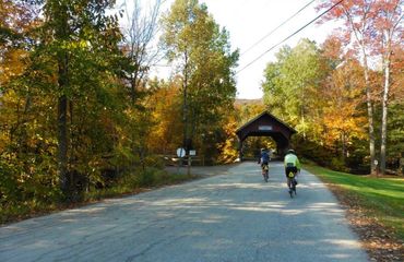 Cycling towards a covered bridge