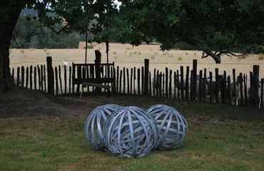 Ball sculptures in field