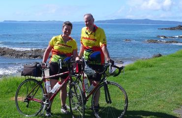 Cyclists standing by the sea
