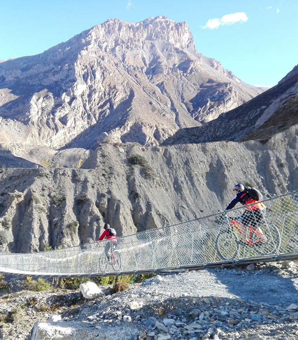 An exhilarating bike ride along the Annapurna Circuit's challenging trails, surrounded by Nepal's majestic landscapes