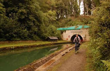 Cyclist biking along a canal