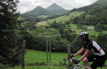 Cyclist looking over green hills