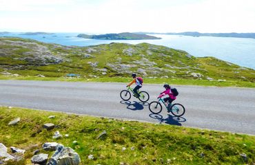 Cyclists riding island road
