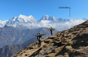Cyclists carrying bikes up mountain near Everest