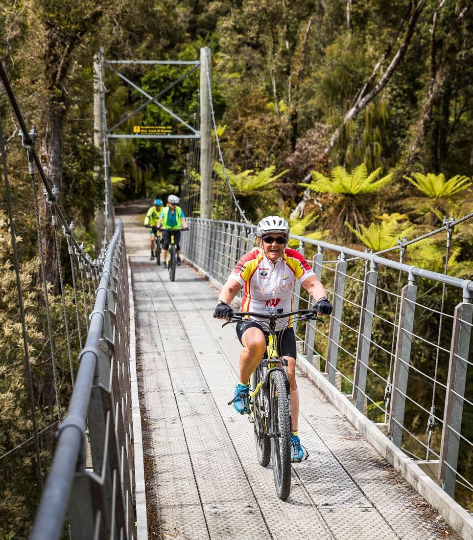 Bike over bridges, next to lakes and through the wilderness