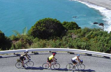 Three road cyclists on coast road