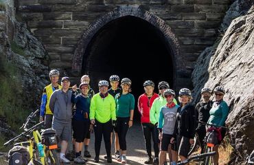 Group of cyclists infront of tunnel