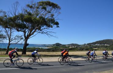 Group of cyclists riding coastal road