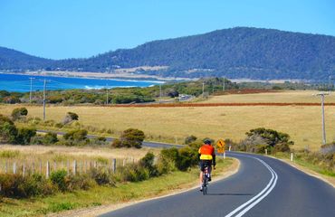 Road cycling with coast in view