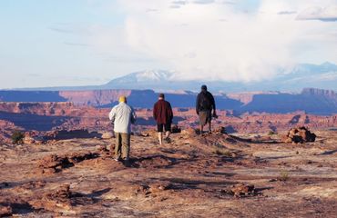 People walking over rocky terrain