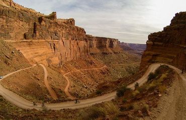 Cycling along dirt road in canyons
