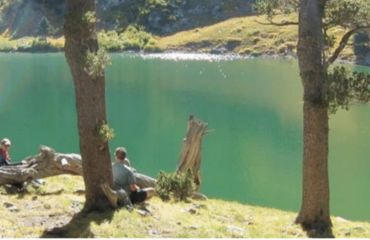 People by turquoise lake