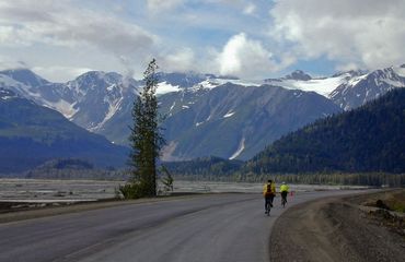 Cycling with snowy mountains in background