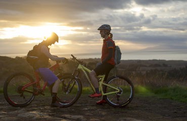 Two cyclists at sunset
