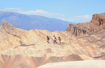 People walking in desert mountain scenery