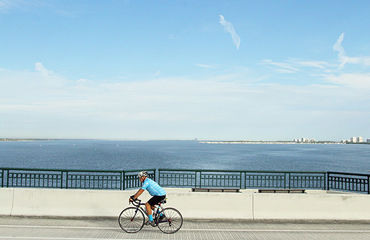 Cyclist riding next to water