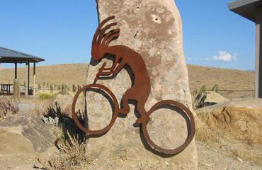 Rusty metal shape of figure on bike