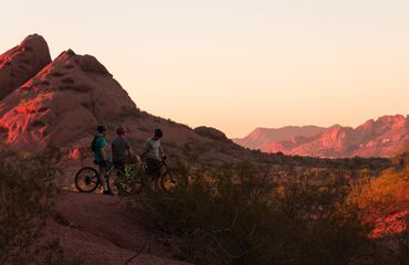 Cyclists in red mountain landscape