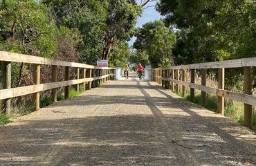 Cyclists riding up to a bridge