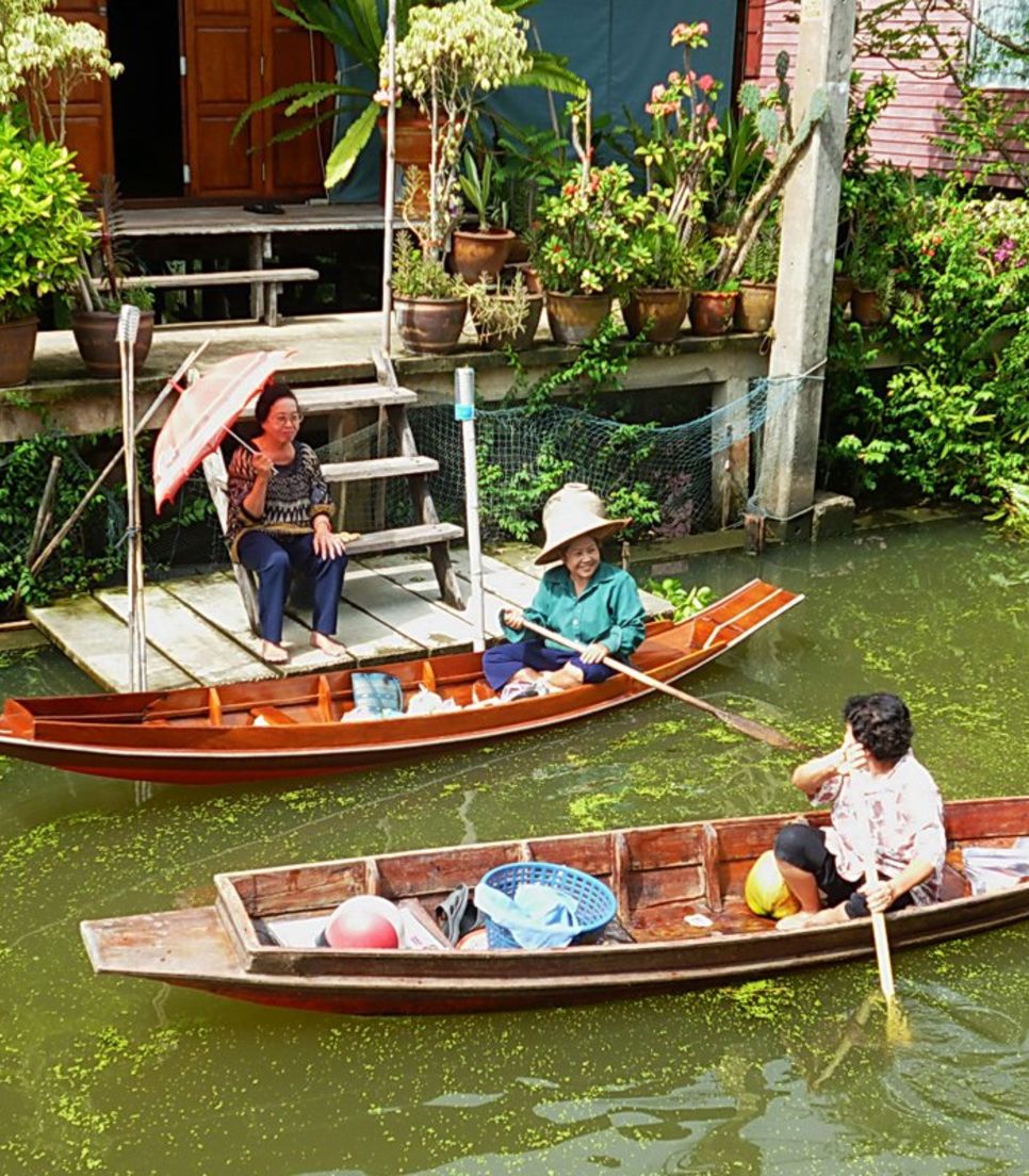 Extend a friendly wave as you travel the floating market. It will be returned in spades!